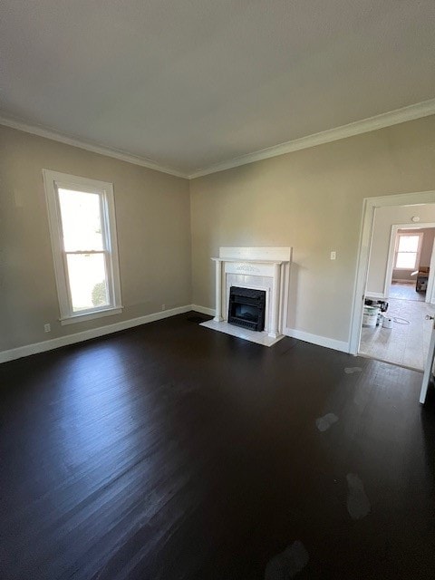 unfurnished living room featuring dark hardwood / wood-style flooring and ornamental molding