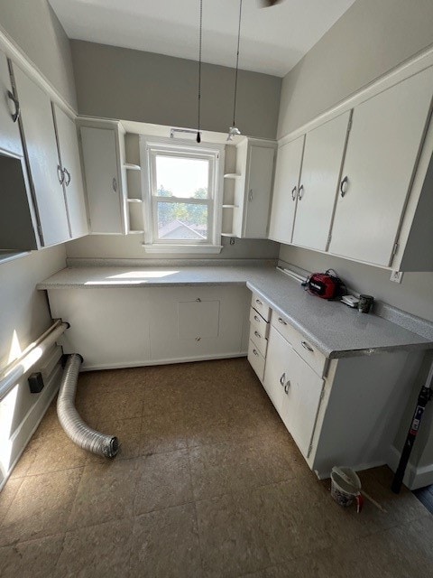 kitchen featuring white cabinetry and decorative light fixtures