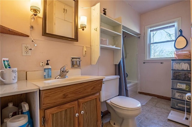 3939 NE Court Dr, Decatur, IL 62526 - bathroom featuring toilet, vanity, shower / washtub combination, and baseboards