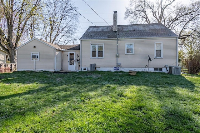 3939 NE Court Dr, Decatur, IL 62526 - back of house with central AC, a chimney, and a lawn