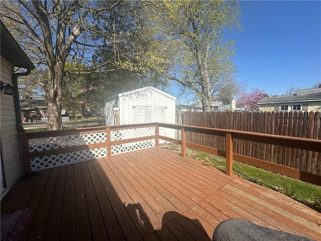 deck with fence and an outbuilding