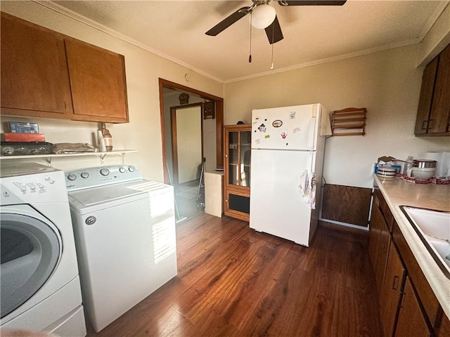 laundry area featuring a ceiling fan, crown molding, dark wood-style flooring, laundry area, and independent washer and dryer