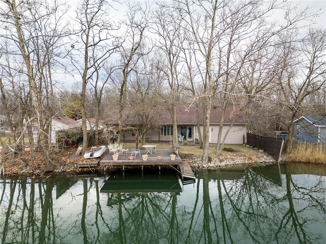 view of dock featuring fence and a water view