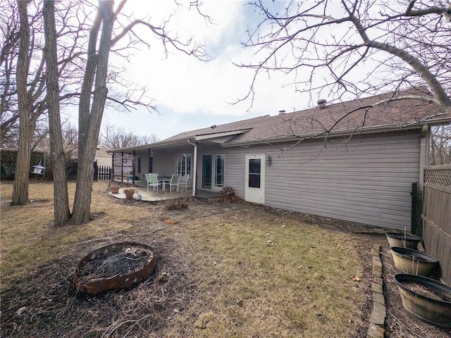 back of property with a patio area, an outdoor fire pit, and fence