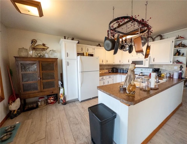 kitchen featuring white appliances, light wood-style floors, tasteful backsplash, and open shelves