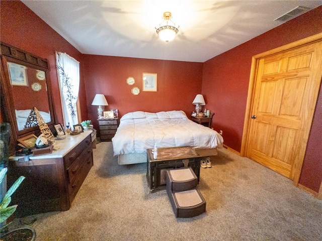 carpeted bedroom featuring visible vents and baseboards