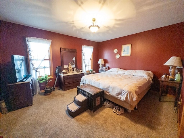 bedroom featuring light colored carpet