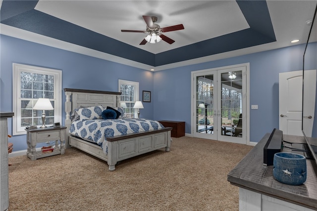 bedroom featuring carpet, access to outside, a raised ceiling, and ceiling fan