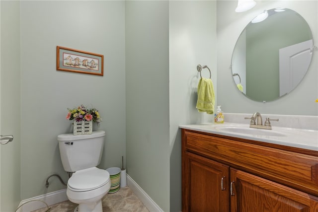 bathroom with tile patterned flooring, vanity, and toilet