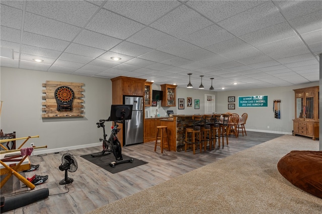 workout area featuring bar area and wood-type flooring