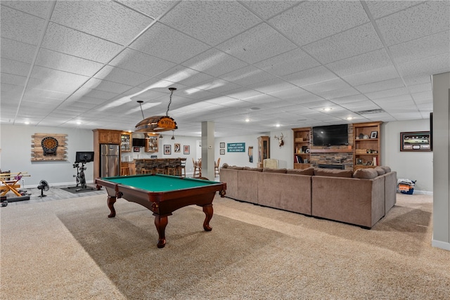 rec room featuring a drop ceiling, a stone fireplace, light carpet, and billiards