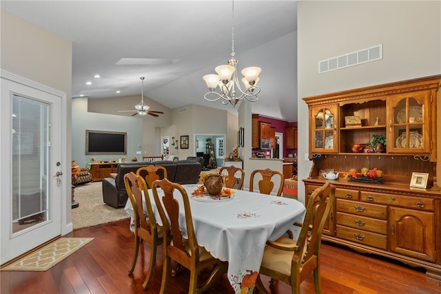 dining area with dark hardwood / wood-style flooring, ceiling fan with notable chandelier, and lofted ceiling