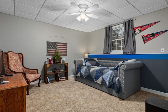 bedroom with light carpet, a paneled ceiling, and ceiling fan