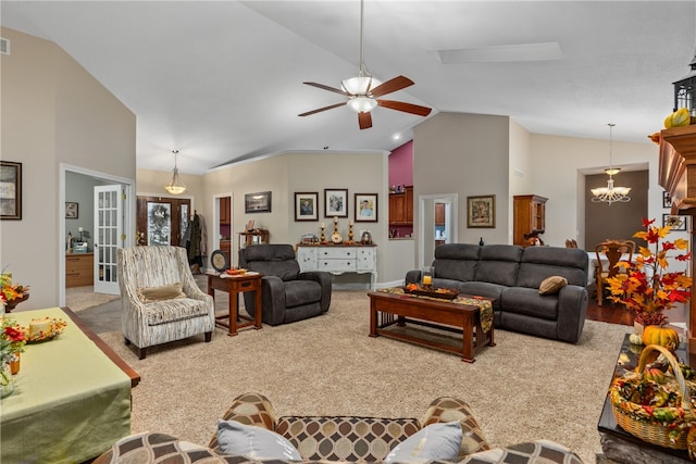 living room featuring carpet, french doors, ceiling fan with notable chandelier, and high vaulted ceiling