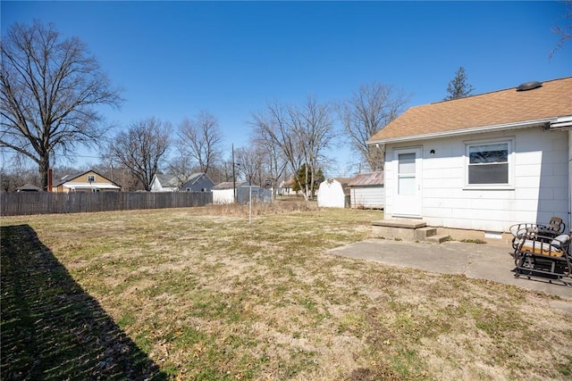 view of yard featuring a patio area, entry steps, and fence