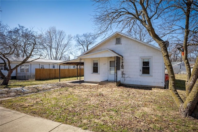 bungalow-style house with an attached carport and fence