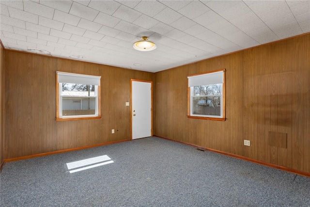 carpeted empty room featuring visible vents and baseboards