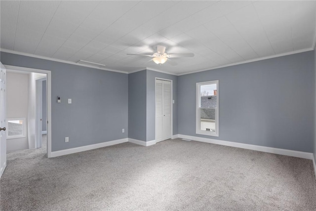 unfurnished bedroom with carpet, crown molding, and baseboards