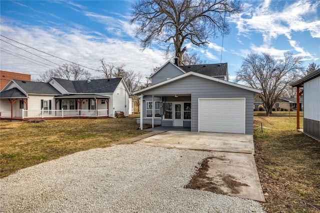 view of front of home featuring an attached garage, covered porch, driveway, and a front lawn