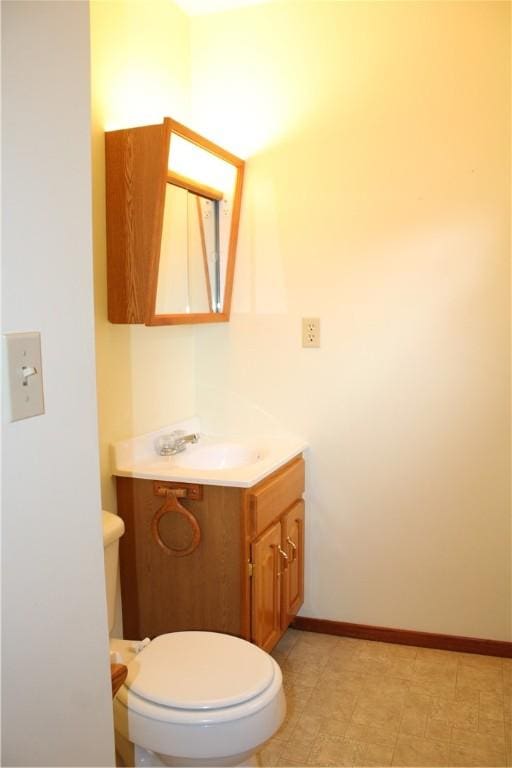 1107 N Long St, Shelbyville, IL 62565 - half bathroom with vanity, toilet, and baseboards