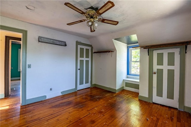 bonus room with wood-type flooring, ceiling fan, lofted ceiling, and baseboards
