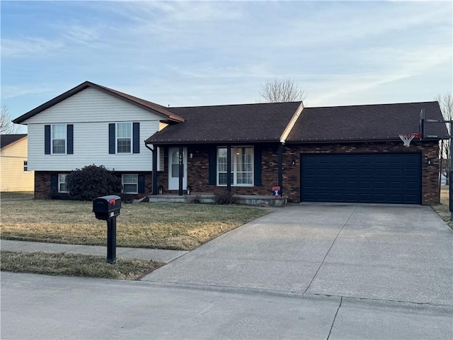 split level home with a garage, brick siding, driveway, roof with shingles, and a front yard