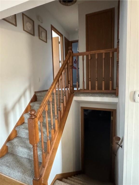 staircase featuring baseboards