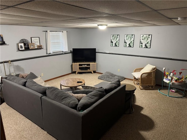 carpeted living area with baseboards and a drop ceiling