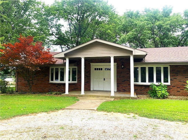 view of front of property with a porch and a front yard