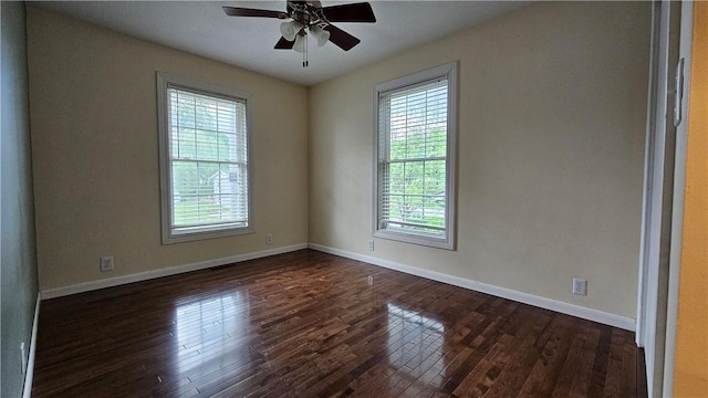 1009 E Grove Pl, Effingham, IL 62401 - empty room with dark wood finished floors, a ceiling fan, and baseboards