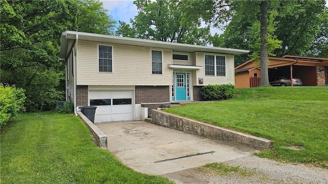 1009 E Grove Pl, Effingham, IL 62401 - raised ranch with a garage, concrete driveway, brick siding, and a front yard