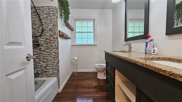1009 E Grove Pl, Effingham, IL 62401 - bathroom with toilet, wood finished floors, double vanity, baseboards, and bathing tub / shower combination