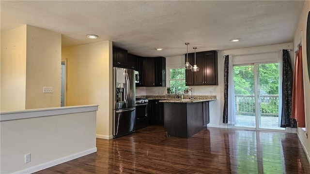 1009 E Grove Pl, Effingham, IL 62401 - kitchen with stainless steel appliances, dark wood-type flooring, a textured ceiling, baseboards, and hanging light fixtures