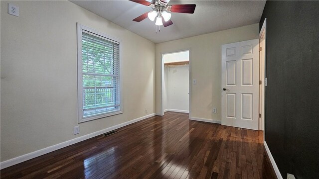 1009 E Grove Pl, Effingham, IL 62401 - unfurnished bedroom featuring wood-type flooring, baseboards, and a ceiling fan