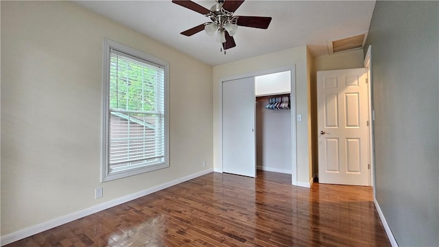 1009 E Grove Pl, Effingham, IL 62401 - unfurnished bedroom with wood finished floors, baseboards, a ceiling fan, and attic access