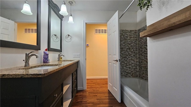 1009 E Grove Pl, Effingham, IL 62401 - full bathroom with wood finished floors, bathtub / shower combination, and double vanity
