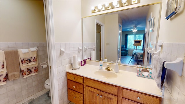 3121 Stoneridge Ct, Danville, IL 61832 - full bath with tile walls, vanity, tile patterned flooring, ceiling fan, and a wainscoted wall