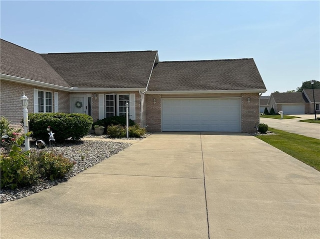 3121 Stoneridge Ct, Danville, IL 61832 - view of front of home featuring brick siding, a garage, driveway, and roof with shingles