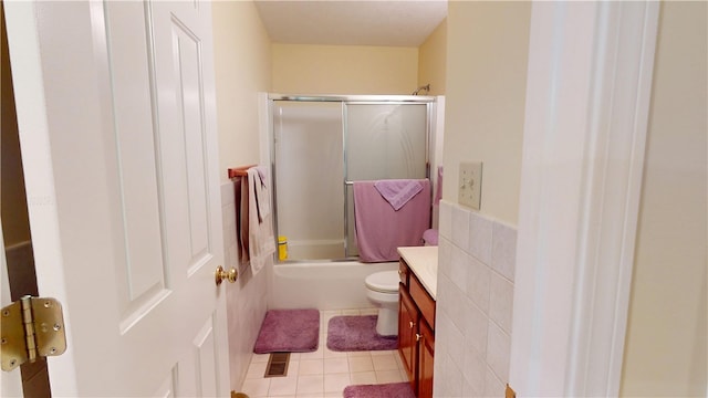3121 Stoneridge Ct, Danville, IL 61832 - full bathroom featuring vanity, enclosed tub / shower combo, tile patterned flooring, and tile walls