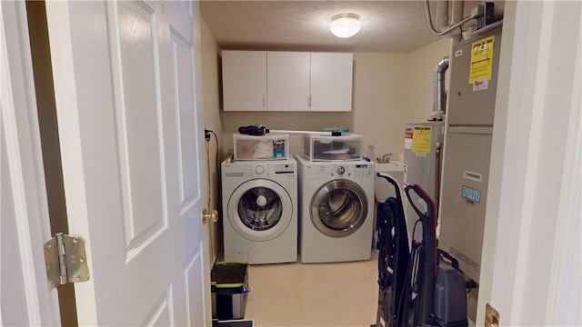 3121 Stoneridge Ct, Danville, IL 61832 - laundry room featuring separate washer and dryer, cabinet space, and a textured ceiling
