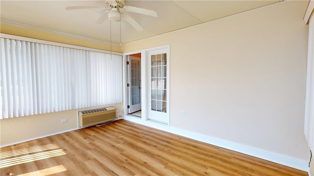 3121 Stoneridge Ct, Danville, IL 61832 - empty room featuring a wall mounted AC, wood finished floors, and a ceiling fan