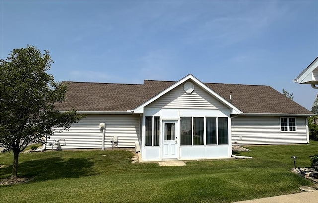 3121 Stoneridge Ct, Danville, IL 61832 - back of property with a sunroom, a lawn, and a shingled roof