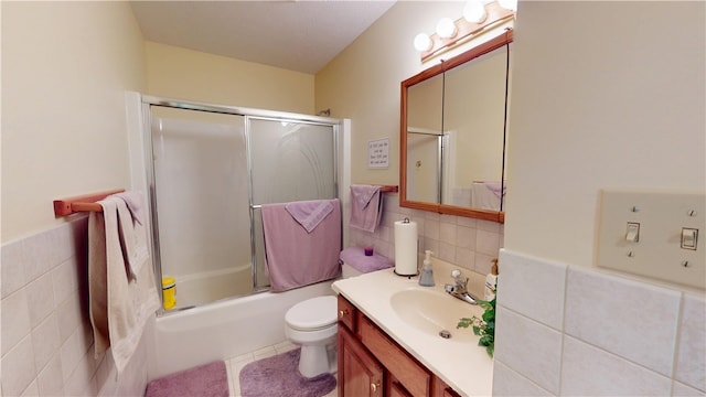 3121 Stoneridge Ct, Danville, IL 61832 - full bath with tile walls, vanity, combined bath / shower with glass door, a wainscoted wall, and tile patterned floors