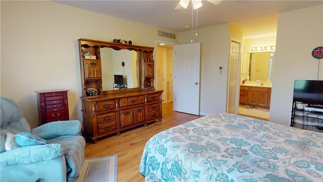 3121 Stoneridge Ct, Danville, IL 61832 - bedroom with light wood finished floors, ensuite bathroom, and ceiling fan
