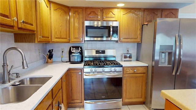 3121 Stoneridge Ct, Danville, IL 61832 - kitchen with appliances with stainless steel finishes, brown cabinetry, and light countertops