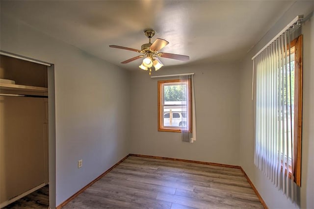 6145 Sangamon Rd, Decatur, IL 62521 - unfurnished bedroom with a closet, wood finished floors, and ceiling fan