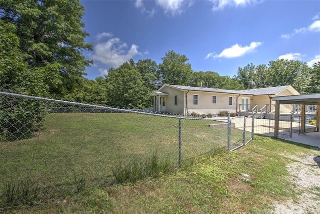 6145 Sangamon Rd, Decatur, IL 62521 - fenced yard featuring a carport