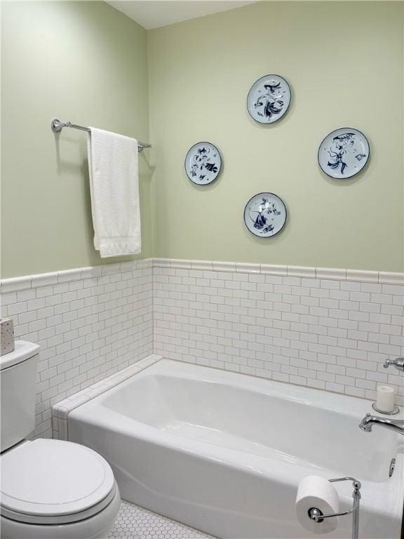 2236 Seneca Dr, Charleston, IL 61920 - full bathroom with a bath, tile patterned floors, wainscoting, toilet, and tile walls