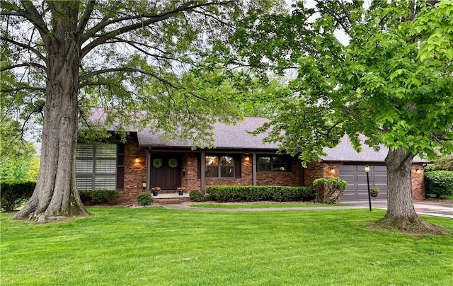 2236 Seneca Dr, Charleston, IL 61920 - view of front of home featuring a front lawn, an attached garage, driveway, and brick siding