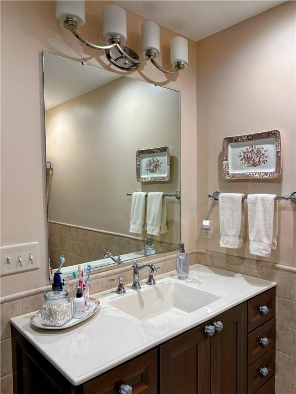 2236 Seneca Dr, Charleston, IL 61920 - bathroom featuring tile walls, vanity, and a wainscoted wall